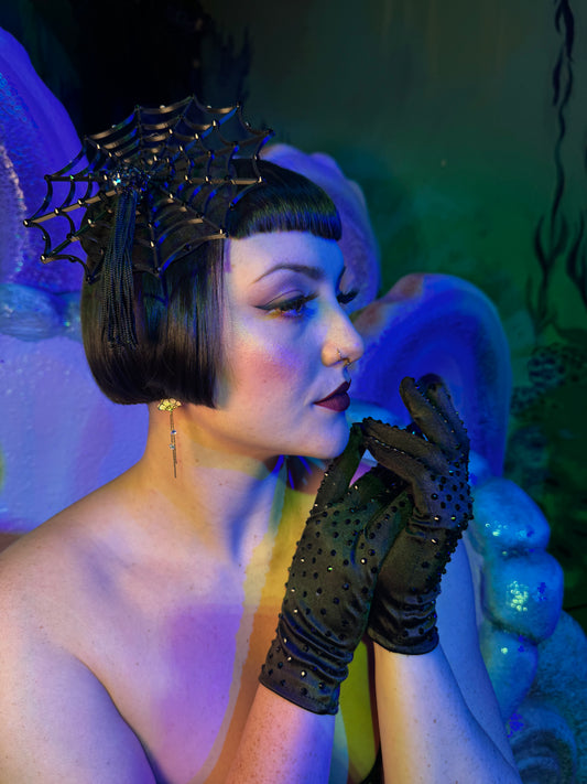 Cierra Bliss wearing classic short black rhinestone gloves with spider fascinator 